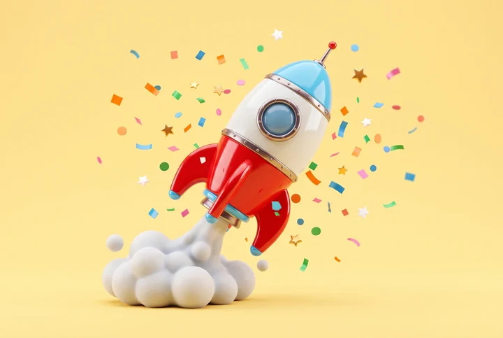 A toy rocket launching through confetti